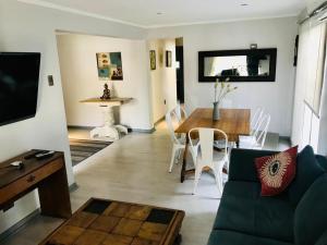 ein Wohnzimmer mit Sofa und Tisch in der Unterkunft Mahiahouse in Santiago