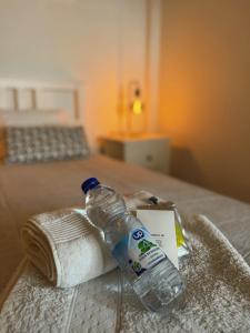 a bottle of water sitting on top of a bed at Cantinho da Avó Mifá in Lisbon