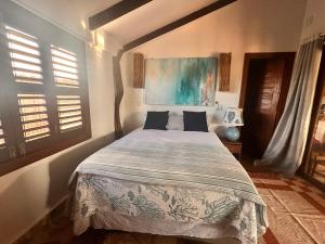 a bedroom with a large bed in a room with windows at Refúgio prea in Cruz +11 photos