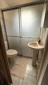 a bathroom with a toilet and a sink at Chácara Canto Dos Pinheiros in Vargem Grande Paulista +22 photos