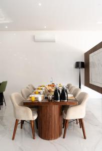 a wooden table with chairs around it in a room at Villa Ramona, Calme, Luxe et Piscine in Marrakesh