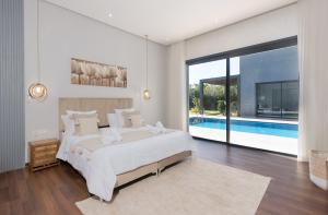 a bedroom with a large bed and a swimming pool at Villa Ramona, Calme, Luxe et Piscine in Marrakesh