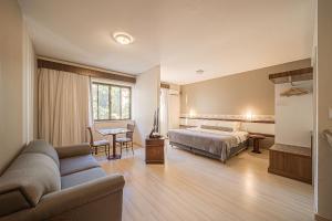a hotel room with a bed and a couch at Hotel Prinz - PRZ000 in Joinville +53 photos