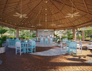 a restaurant with blue tables and chairs under a tent at Iberostar Selection Riviera Cancun - All Inclusive in Puerto Morelos