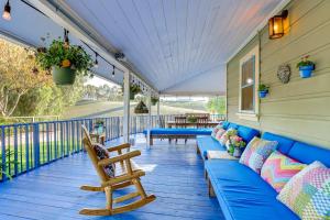 a porch with a blue couch and a chair at 28 Acres in Wine Country! Central California Oasis in Estrella