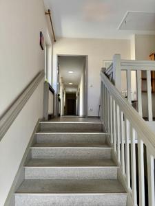 a hallway with stairs in a building at Gasthaus Paus in Götzendorf an der Leitha +29 photos
