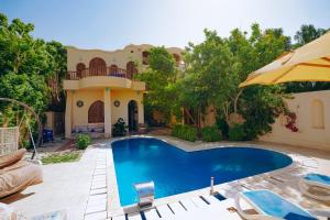 a swimming pool in front of a house at Tunis castle in ‘Izbat an Nāmūs
