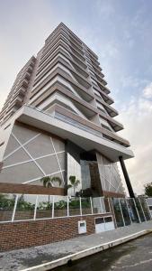 a tall white building with a brick at Priority Praia grande in Praia Grande +25 photos