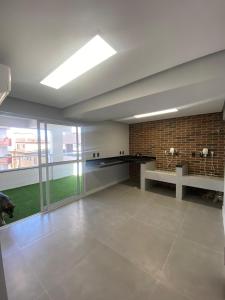 a large room with a sink and a counter at Priority Praia grande in Praia Grande