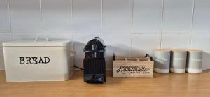 a kitchen counter with a blender and a trash can at 59 De Valle, Diaz Beach in Mossel Bay