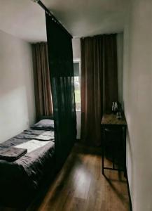 a bedroom with a bed and a table and a window at Pyrzowice noclegi AirNest 8 min od Lotniska Katowice Airport 