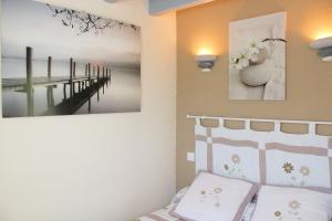 a bedroom with a bed and two pictures on the wall at La Roche Bleue in Saint-Bois
