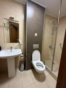 a bathroom with a toilet and a sink and a shower at Hotel Royal Harmony in Tbilisi City +15 photos