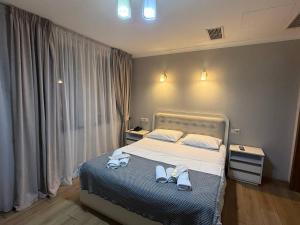 a bedroom with a bed with towels on it at Hotel Royal Harmony in Tbilisi City