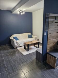 a living room with a couch and a coffee table at Au Clerc de Lune in Broye