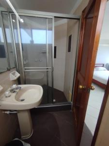a bathroom with a sink and a glass shower at Alojamientovacacional657 in Rodadero