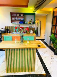 a kitchen with a table with a vase of flowers on it at Résidence de la Paix in Yaoundé +24 photos