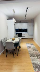 a kitchen and dining room with a table and chairs at Gloria New Bazaar Apartment in Tirana +11 photos