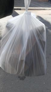 a white plastic bag sitting on the street at Descanso merecido in Goiânia