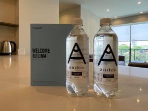 two bottles of water sitting on a table at Modern 2BR with Balcony in San Isidro in Lima +16 photos