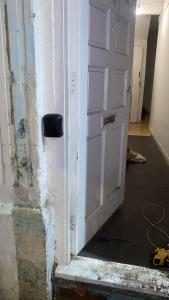 a white door in a room with a wall at EAST HAM HOME SHARe in London