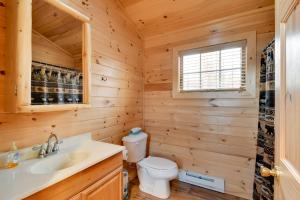 a log cabin bathroom with a toilet and a window at Shared Dock Access at Lakeside Sodus Bay Cabin! in North Rose +22 photos
