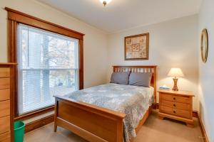 a bedroom with a bed and a window at Lake Access and Incredible Views at Sodus Bay Home! in North Rose
