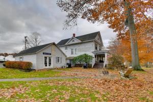 a white house with autumn leaves on the yard at Lake Access and Incredible Views at Sodus Bay Home! in North Rose