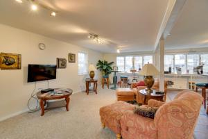 a living room with a couch and a tv at Lake Access and Incredible Views at Sodus Bay Home! in North Rose