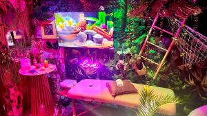 a room with a pink table and a sign that says love at Un Mirage Tropical - Bulles , Spa & Détente en Bord de Loire in Saint-Clément-des-Levées