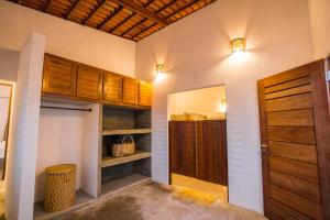 a room with wooden cabinets and a door at Casa Galo Pretto in Galinhos +52 photos