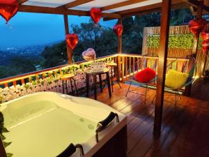 a bath tub on a balcony with a table and chairs at Glamping STELAR VILLA EL EDEN in Cali