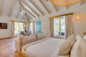 a bedroom with a large white bed in a room at Blue Reef Beach and Marina in Placencia +130 photos