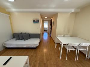 a living room with a couch and a table and chairs at SP 43 Vut in Lugo