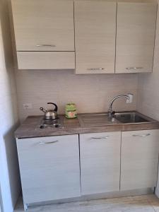 a small kitchen with white cabinets and a sink at Affittacamere Massimo D'Azeglio in Barletta
