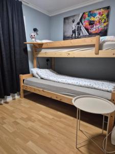 a bedroom with two bunk beds and a chair at Senja 4 Summit in Torsken