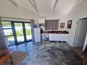 a kitchen with a white refrigerator and a table at 66onjennings Strand in Strand