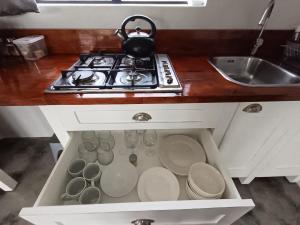 a kitchen counter with a stove and some dishes at 66onjennings Strand in Strand +17 photos