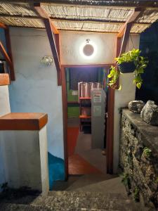 an entrance to a kitchen with a refrigerator in a room at Hostel Sunrise in Rio de Janeiro