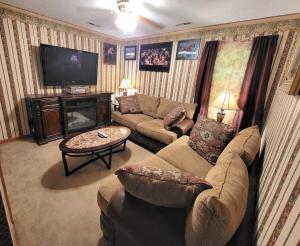 a living room with a couch and a tv at Wildwood Estates in Lynchburg
