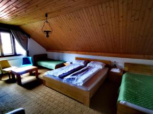 a bedroom with a bed and a chair and a table at Planinski Mir in Zaovine