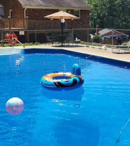 an orange and blue raft in a swimming pool at Wildwood Estates in Lynchburg
