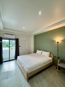 a bedroom with a large bed and a large window at W Smart Stay TRANG in Trang +35 photos