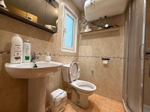 a bathroom with a sink and a toilet and a window at SP 64 Vut in Lugo