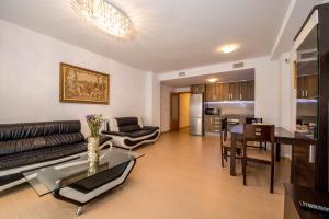 a living room with a couch and a table at Apartments Slice of Life in Torrevieja