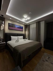 a bedroom with a large bed with a tv on the ceiling at Vila Golija Peak Suites in Kopaonik