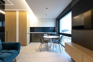 une cuisine et une salle à manger avec une table et des chaises dans l'établissement Central Stay Apartments - 300m from Old town, à Craiova