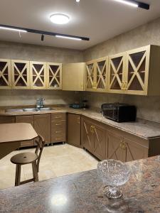 a kitchen with wooden cabinets and a counter top at Twin villa for rent in madinaty in Madinaty