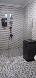 a bathroom with a black tub and a camera on a wall at Villa Panorama Amed in Ambat +25 photos