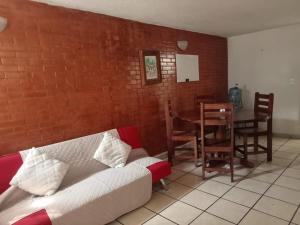 a living room with a couch and a table and chairs at Loft Guelaguetza B in Santa Cruz Huatulco
